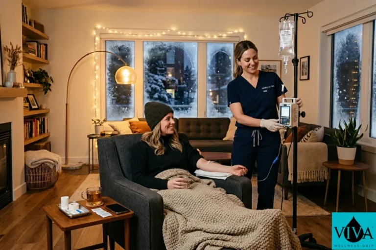 At-home IV drip therapy session in a warm Edmonton living room during winter, snow visible through a frosted window