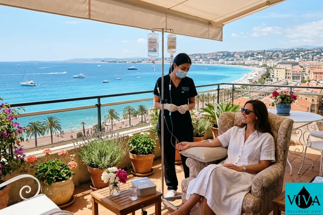 Mobile IV drip therapy session set up on a sun-filled Nice apartment terrace overlooking the Baie des Anges and the Mediterranean
