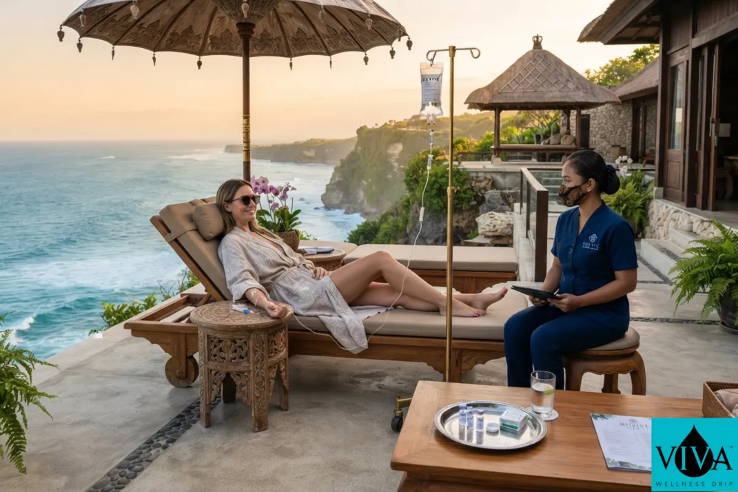 A mobile IV drip therapy session set up on a cliff-side villa terrace overlooking the ocean in Uluwatu, Bali